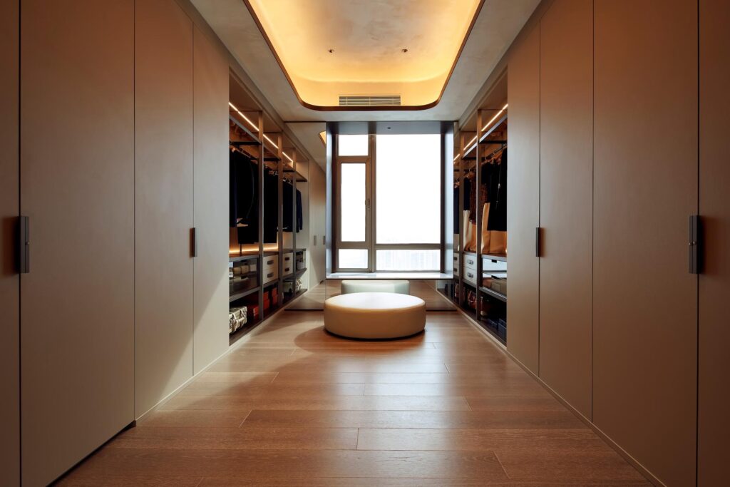 Luxury walk-in closet with built-in shelving and hidden storage