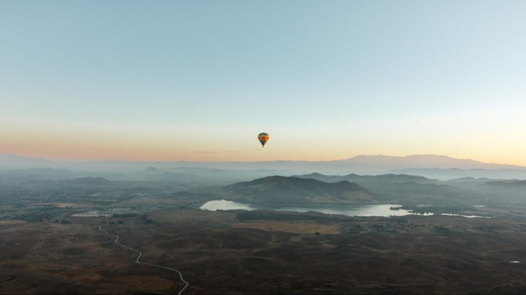 Hot air balloon over Temecula Valley with Skinner Reservoir in the background