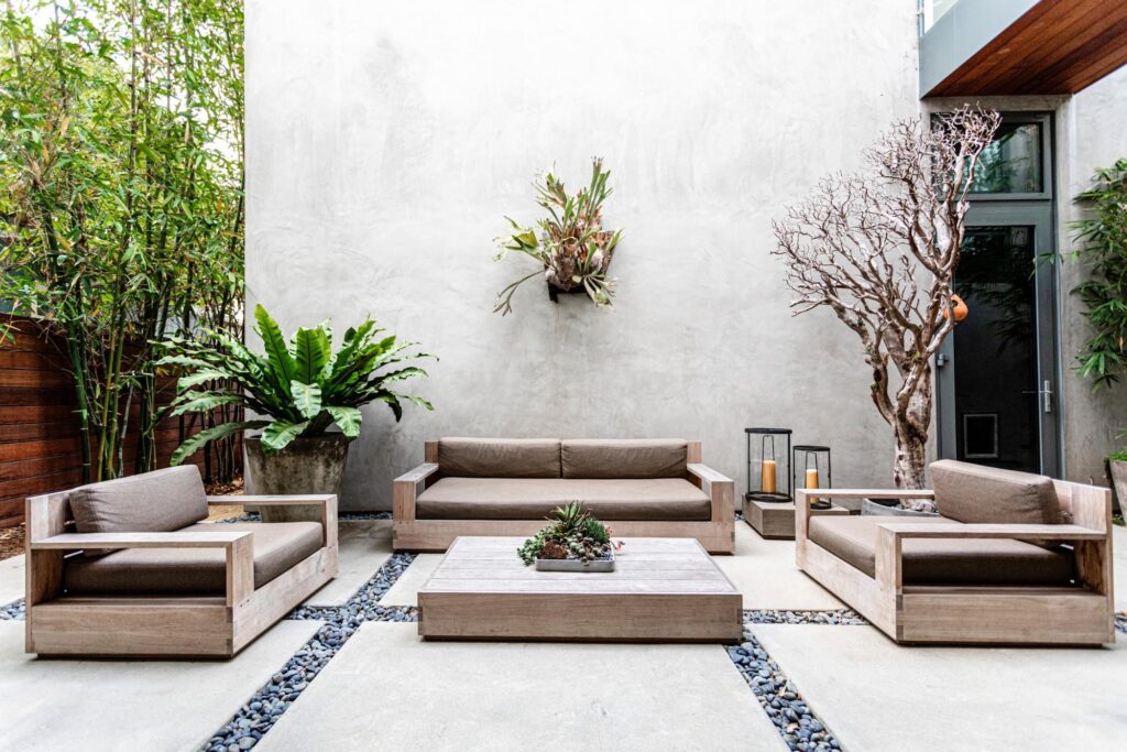 Contemporary outdoor patio with concrete slabs and wood furniture
