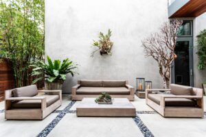 Contemporary outdoor patio with concrete slabs and wood furniture